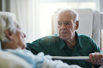 Ill always be by your side. Shot of a senior man visiting his wife in hospital.