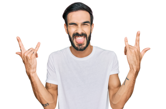 Young hispanic man wearing casual white t shirt shouting with crazy expression doing rock symbol with hands up. music star. heavy concept.