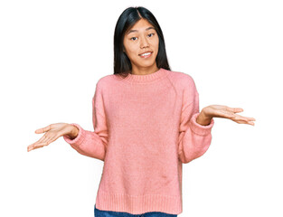 Beautiful young asian woman wearing casual winter sweater clueless and confused expression with...