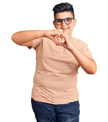 Fototapeta premium Little boy kid wearing casual clothes and glasses smiling in love doing heart symbol shape with hands. romantic concept.