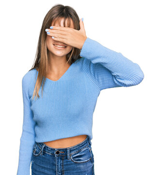 Teenager caucasian girl wearing casual clothes smiling and laughing with hand on face covering eyes for surprise. blind concept.