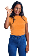 Young indian girl wearing casual clothes and glasses smiling positive doing ok sign with hand and fingers. successful expression.