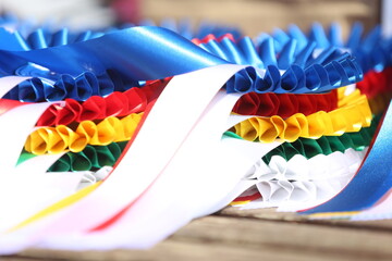 Pile of horse sport trophies rosettes at equestrian event