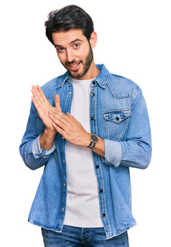 Young hispanic man wearing casual clothes clapping and applauding happy and joyful, smiling proud hands together