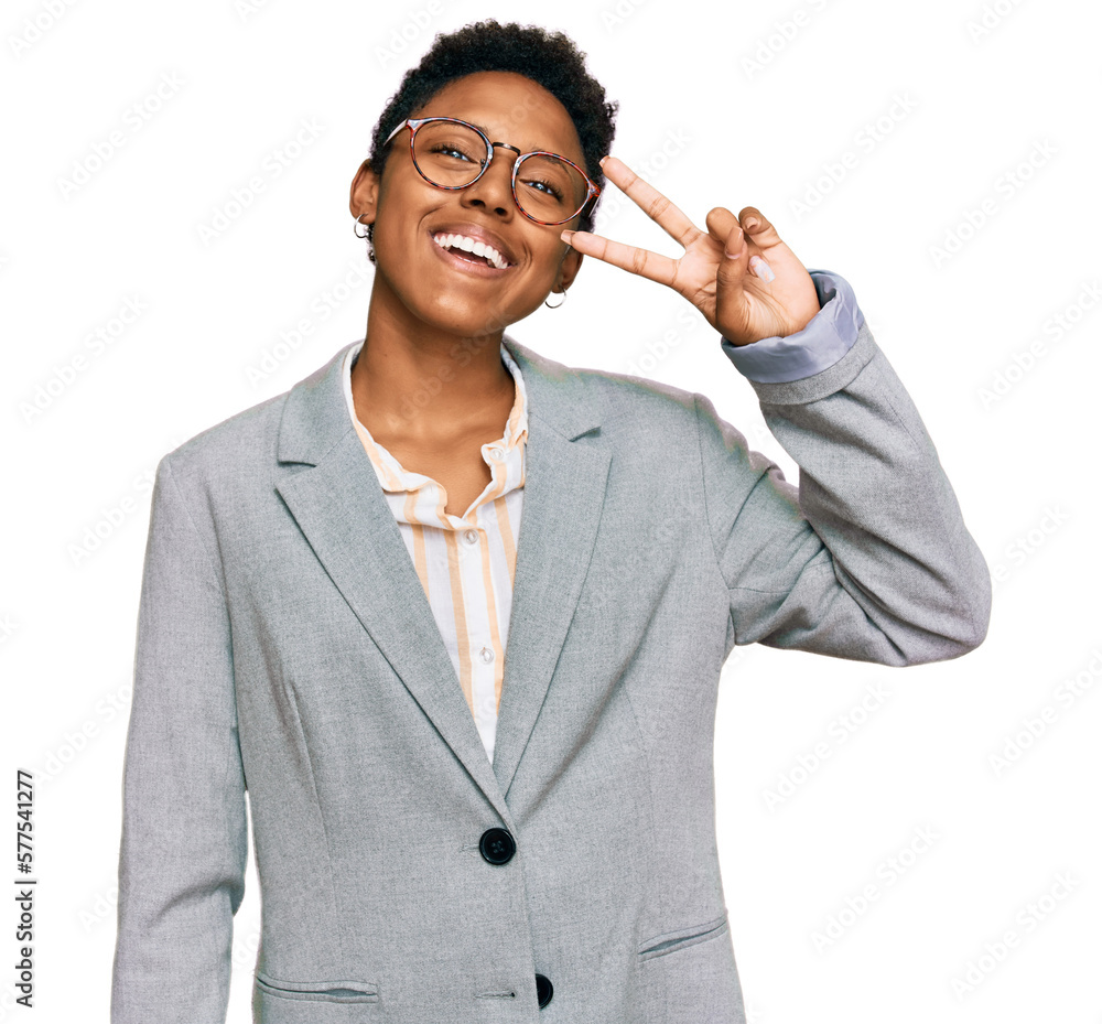 Wall mural young african american woman wearing business clothes doing peace symbol with fingers over face, smi