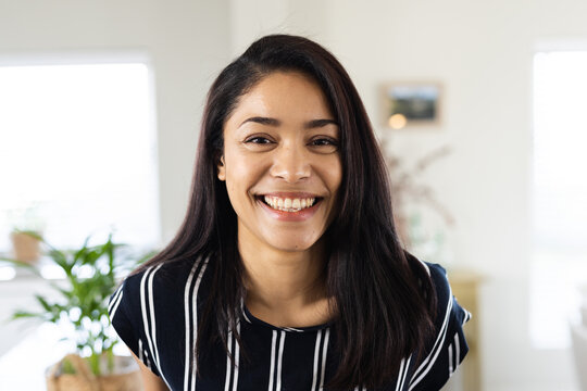 Portrait of happy biracial woman looking at camera and smiling