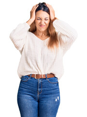 Fototapeta premium Beautiful young woman wearing casual clothes suffering from headache desperate and stressed because pain and migraine. hands on head.
