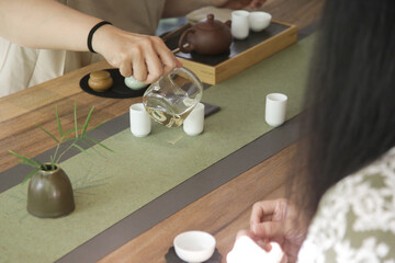 Chinese Tea Ceremony experience. Exquisite hot tea at traditional Chinese Tea Ceremony. Group of women participating in a traditional tea ceremony class, serie of photos.