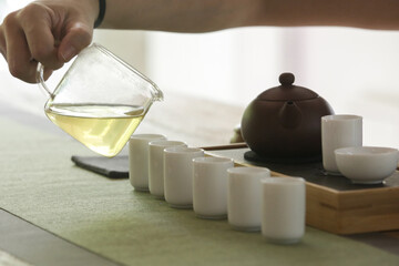 Chinese Tea Ceremony experience. Exquisite hot tea at traditional Chinese Tea Ceremony. Group of women participating in a traditional tea ceremony class, serie of photos.