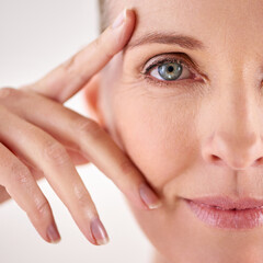 Impressed with the results of her anti-aging cream. Closeup studio portrait of an attractive mature...