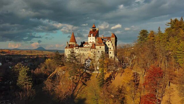 Aerial view of Bran castle in Transylvania region, Romania. Autumn season and dark clouds, 4k