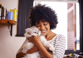 Arent you so cute. Shot of a beautiful young woman enjoying a cuddle with her cat.
