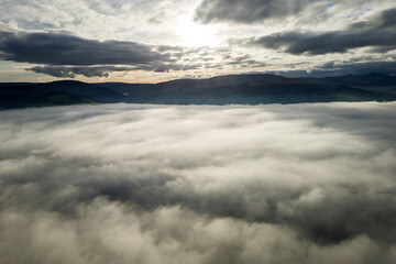 Aerial view of sunset over a bank of fog with distant mountains