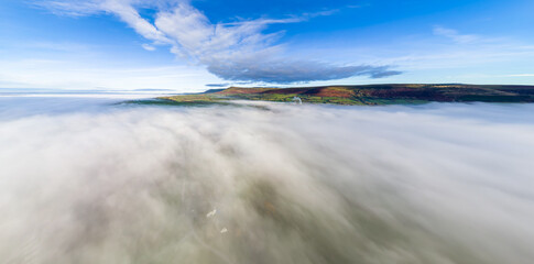Aerial panorama of low fog and distant mountains