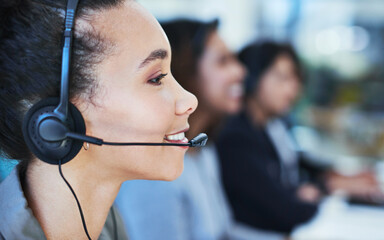 Tell me more about the problem and I will resolve it. Shot of a young woman working in a call centre.