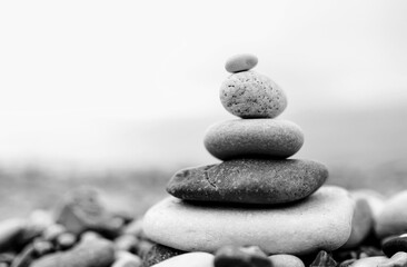 zen stones on the beach. black and white toned image 
