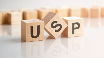 word USP made with wood building blocks, stock image. background may have blur effect