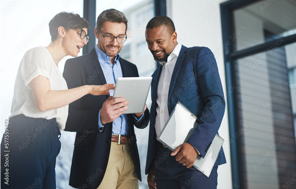 Poster Digitizing business discussions. Shot of a team of colleagues using a digital tablet together at work.