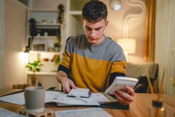 Young caucasian man teenager student study at home at the table night