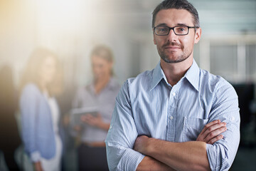 Fototapeta premium Think youve got what it takes. Portrait of a business with his colleagues blurred in the background.