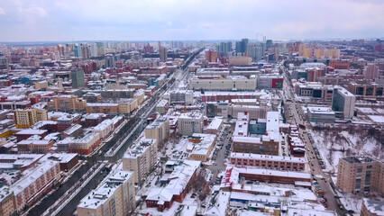 Obraz premium Winter city with high-rise buildings. Clip.View from a helicopter on a city with narrow streets and tall houses