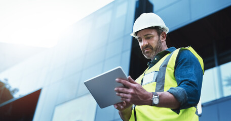 This software help me to keep track of everything. Shot of a engineer using a digital tablet on a...