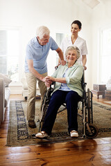 Surrounded by support. Shot of a smiling caregiver with a senior woman in a wheelchair and her...