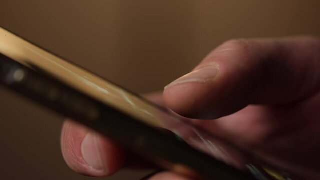 Side view of a man's hand scrolling. Doom scrolling concept