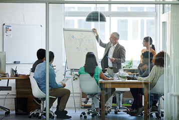 Putting company policies into perspective. Shot of a group of coworkers in a boardroom meeting.