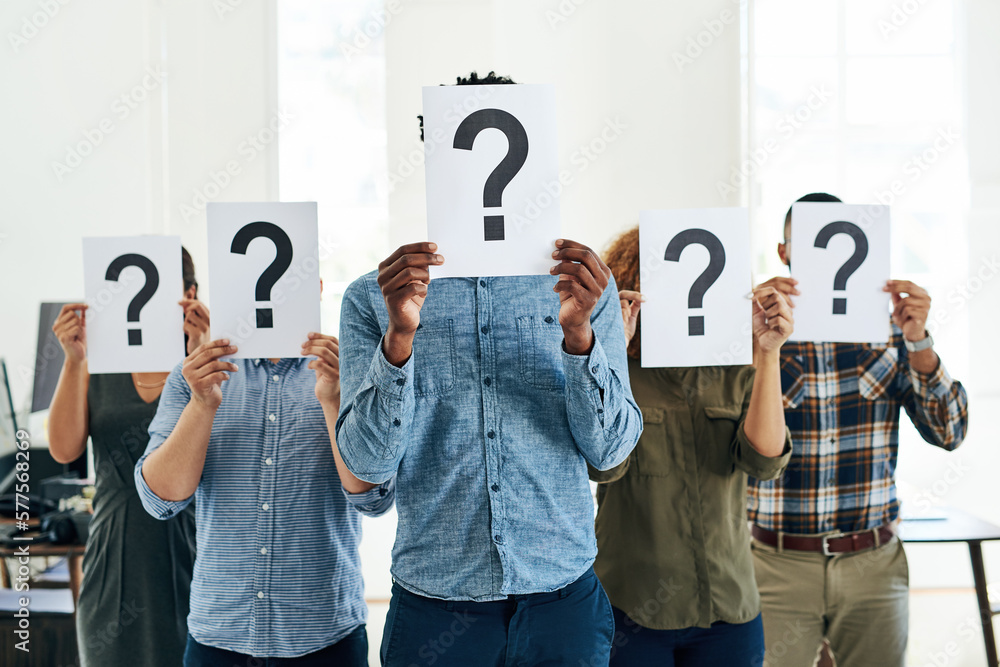 Leinwandbilder who how what where when why. shot of a group of businesspeople holding questions marks in front of t