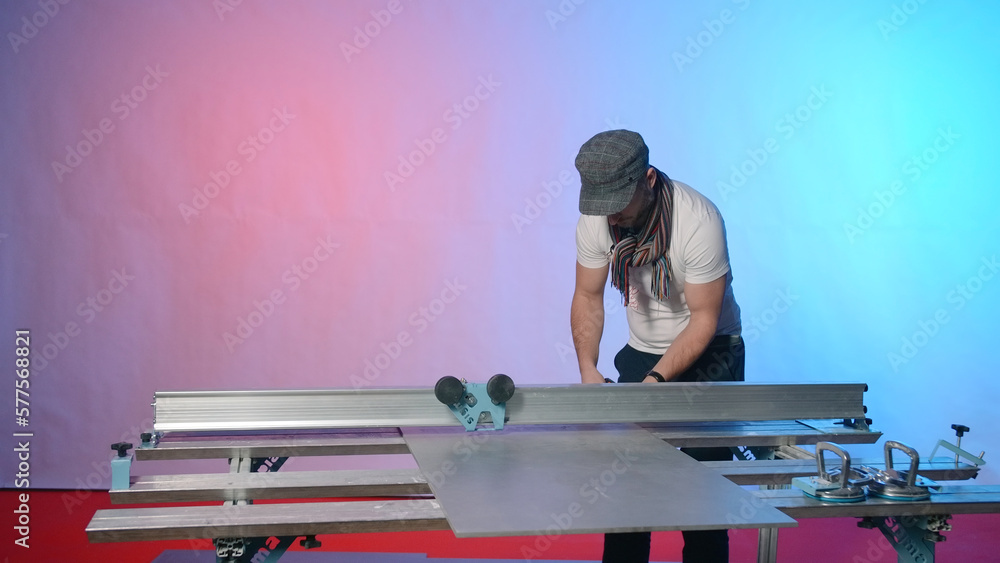 Poster man works at modern carpentry table. creative. modern carpentry table with fixing fasteners and cutt