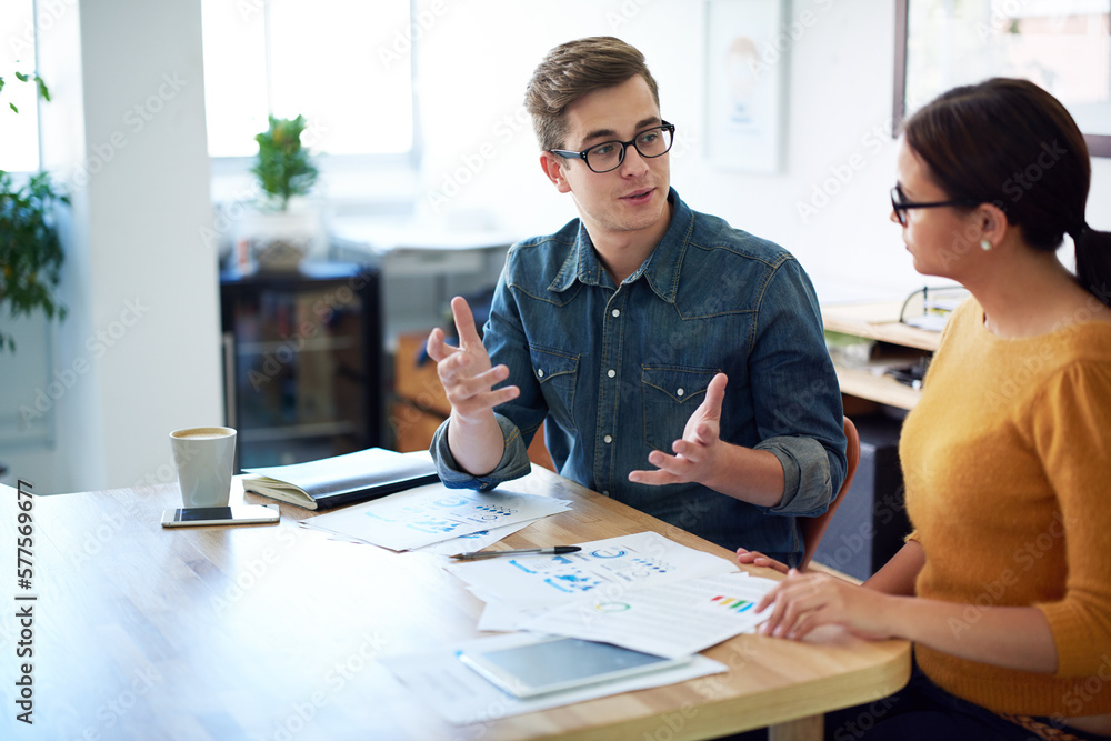 Poster time for a quick brainstorm. cropped shot of two coworkers having a discussion in the office.