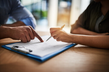 Your details go here. Cropped shot of a man and woman completing paperwork together at a desk.