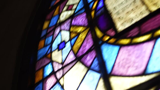 Stained Catholic Church glass with image of the Bible Scripture inside Religious place