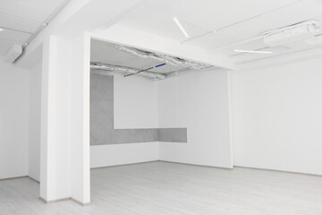 Empty room with white ceiling and ventilation system during repair