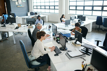 Their strategy for success is hard work. Shot of a group of coworkers sitting at their workstations...