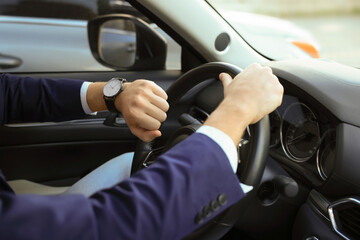 Man checking time in car, closeup. Being late