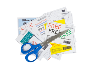 Fake paper coupons with scissor.  All coupons were created by the photographer.  No real ads were used.  Bar codes are fictional.  Isolated with cut out background.  