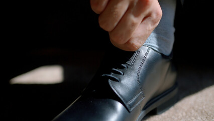 A man going for a walk. Action. New sparkling men's shoes that a man ties.