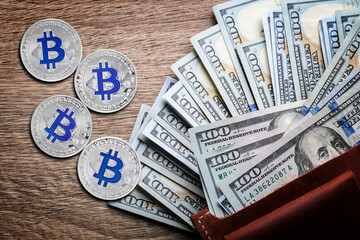 Bitcoins, dollar banknotes and wallet on wooden background, flat lay