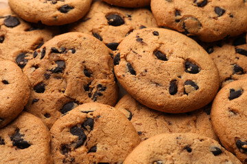 Delicious chocolate chip cookies as background, closeup