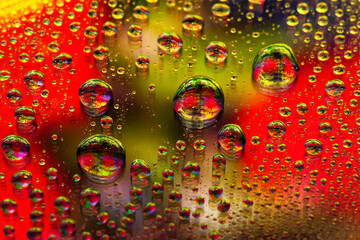 Large water drops. Abstract wet background. Colored macro texture many drops. Rainbow gradient. Heavily textured image. Shallow depth of field. Selective focus