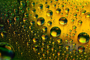 Drops of water. Abstract background. Colored macro texture many drops. Rainbow wet gradient. Heavily textured image. Shallow depth of field. Selective focus