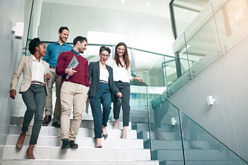 The end of another successful business day. Shot of a group of colleagues talking together while...