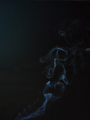 Shapes in motion- Smoke on a dark blue background