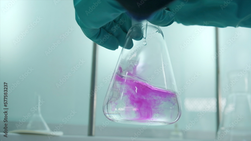 Poster close-up of flask with chemical liquid. clip. laboratory assistant conducts experiments with chemica