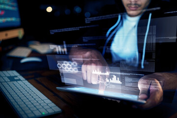 Your network has been breached. Shot of an unidentifiable hacker using a digital tablet in the dark.