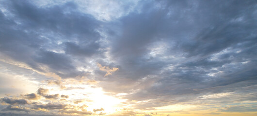 soft light of the evening sun shines on the gray clouds.