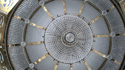 Crystal chandelier in temple. Scene. Beautiful light of crystal chandelier under dome of temple....