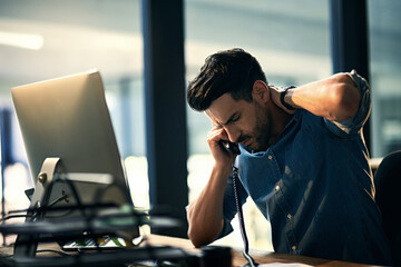 Burnout - bad for business, bad for your health. Shot of a young businessman experiencing stress...